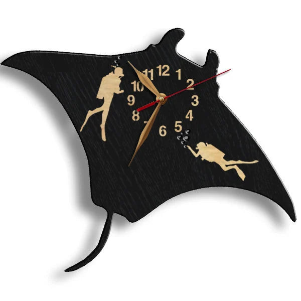 Close-up of diver silhouettes on black manta-shaped clock