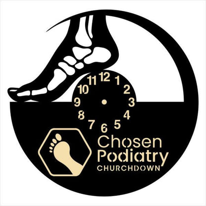 Decorative wall clock showing a foot outline and footprints, personalized with business name
