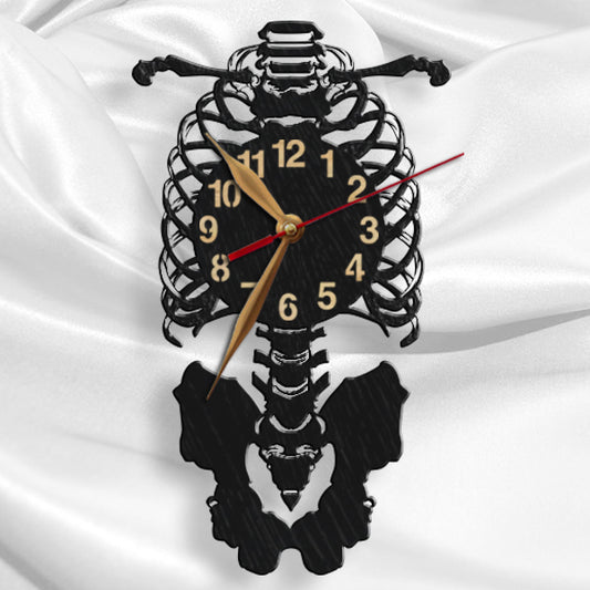 A wall clock featuring a detailed anatomical skeleton design, with a black silhouett
