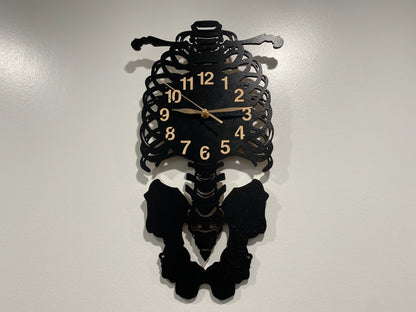 Laser-cut skeleton wall clock featuring ribcage, spine, and pelvis details