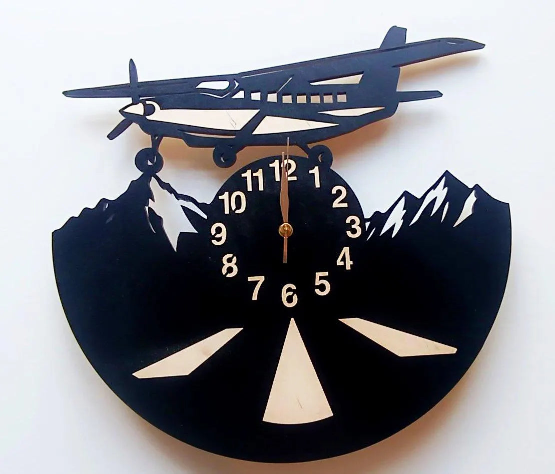 Black airplane wall clock, showing mountains and runway