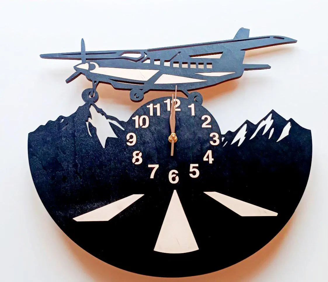 Wall clock with airplane and mountain design