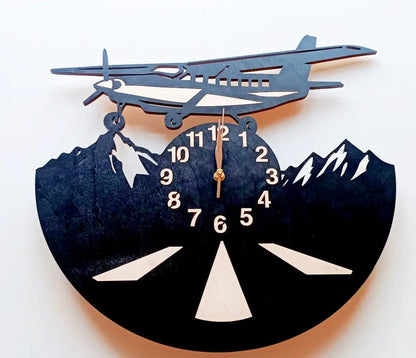 Wall clock with airplane and mountain design