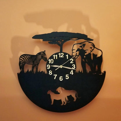 Handcrafted wall clock with zebra, elephant, and lion silhouettes under acacia tree