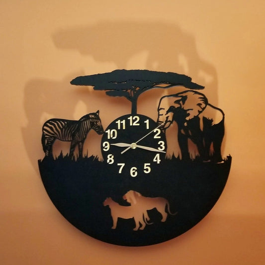 Handcrafted wall clock with zebra, elephant, and lion silhouettes under acacia tree