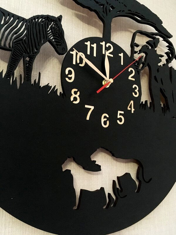 Detail of lion and lioness cut‑out at bottom of personalized safari wall clock