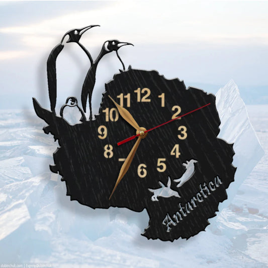 Wall clock shaped like Antarctica with penguins and the word "Antarctica"