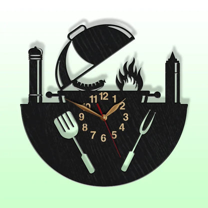 Close-up of wooden barbecue-themed wall clock with utensils and sausage