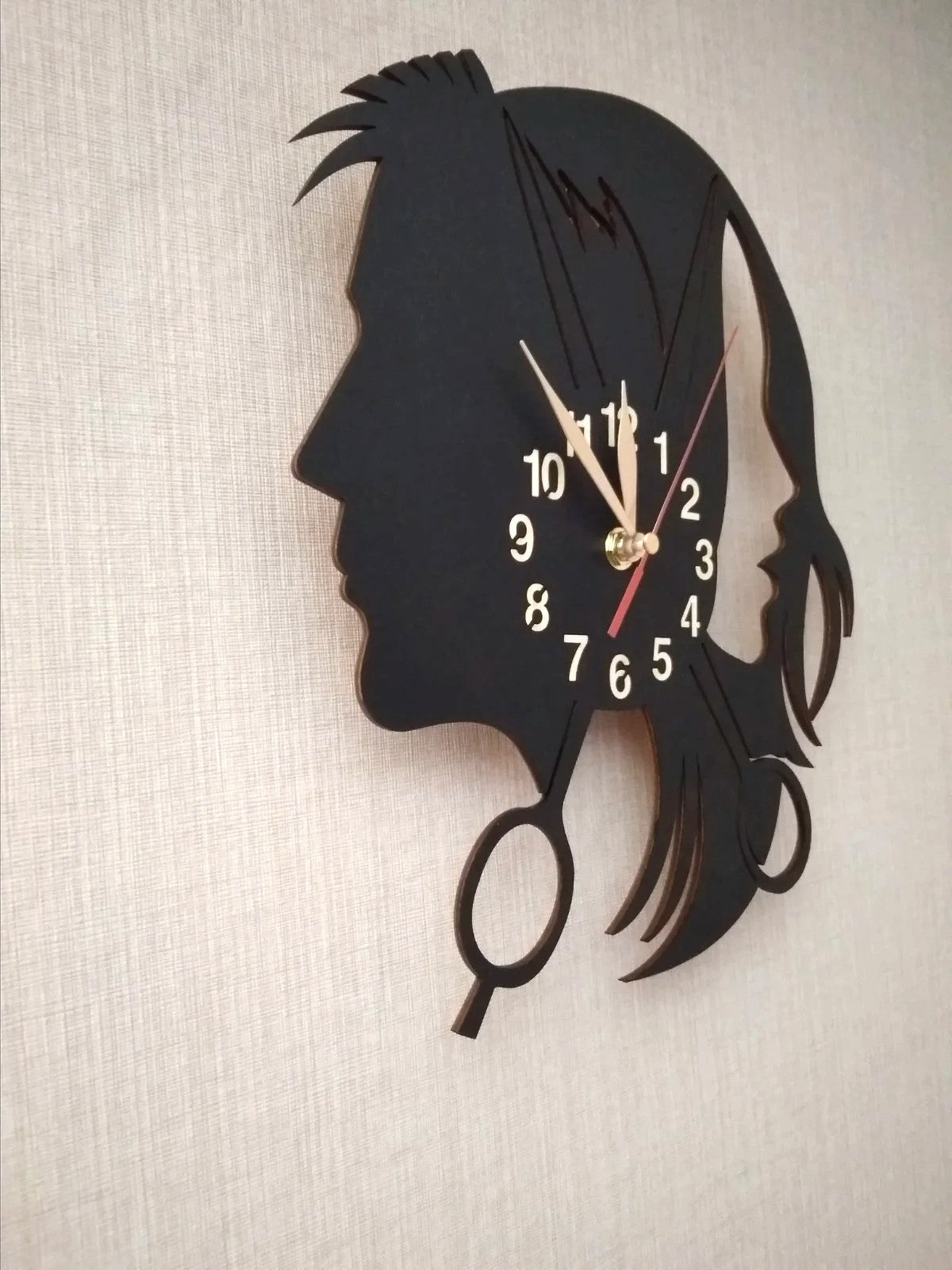 Close-up angle of hairstylist-themed decorative wall clock
