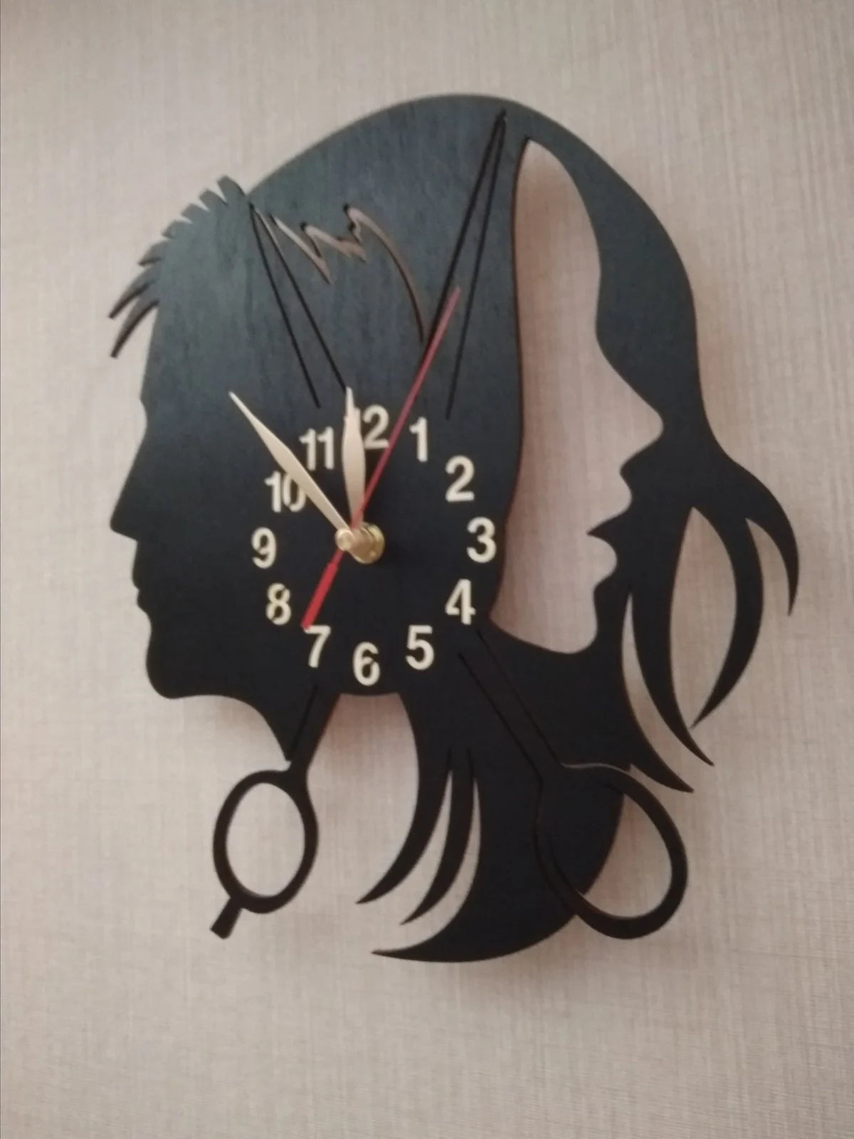 Wall clock with a design for a beauty salon