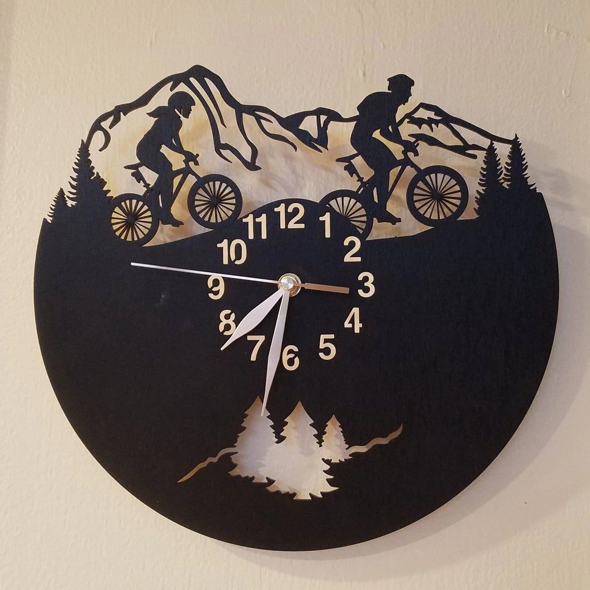 Cycling adventure wall clock with male and female riding together in the mountains