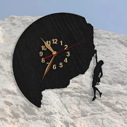 Rock climbing wall clock with a man silhouette on a rugged cliff face