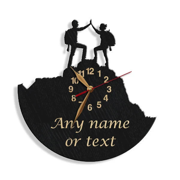 Wall clock showing two hikers on a summit with a custom phrase