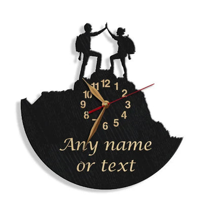 Wall clock showing two hikers on a summit with a custom phrase