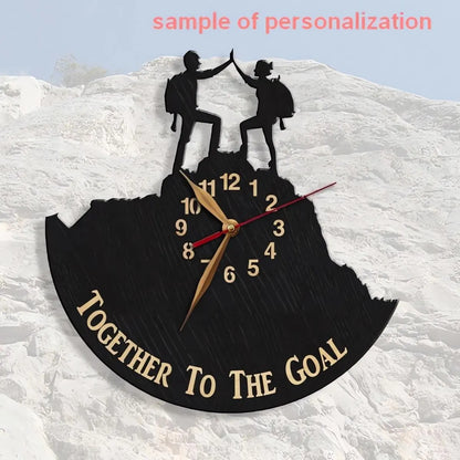 Wooden wall clock with hikers standing together on a peak, customizable with meaningful text.