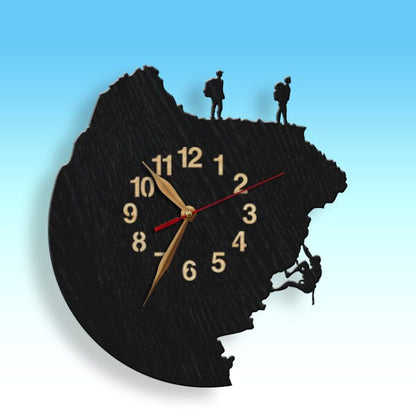 Wall clock with hikers and a rock climber silhouette on a black cliff design
