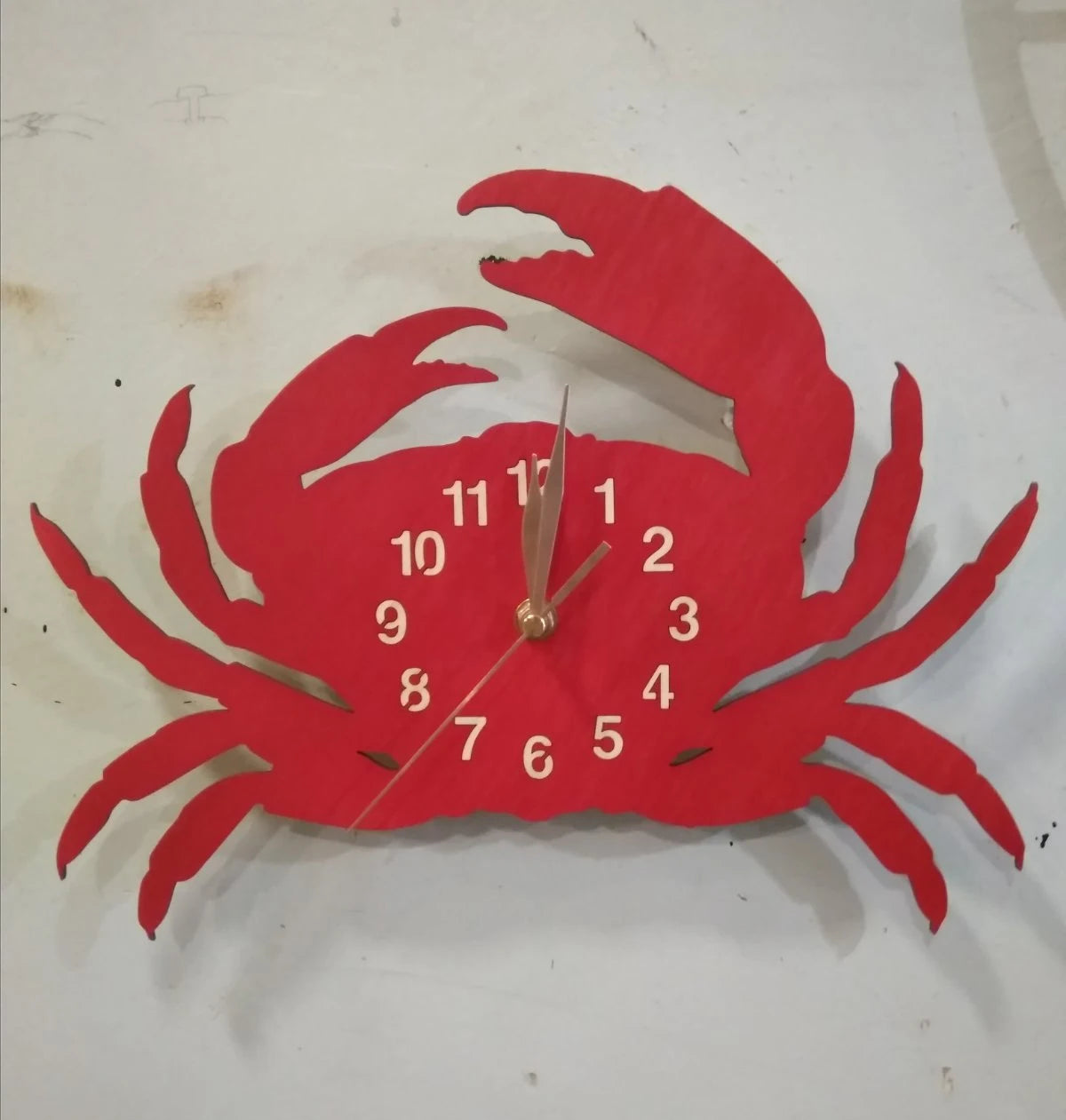 Red crab wall clock mounted on light wall – nautical theme for kitchen or restaurant