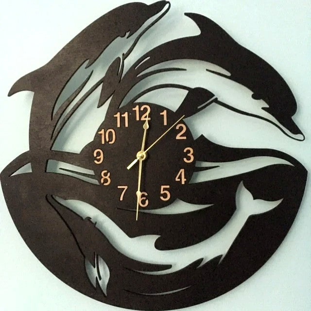 Dolphin-shaped wooden wall clock with three dolphins in motion