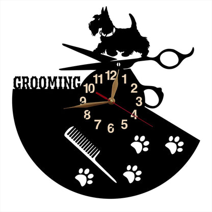 Wall clock with dog grooming design featuring a scotch terier, scissors, and paw prints on a black background.