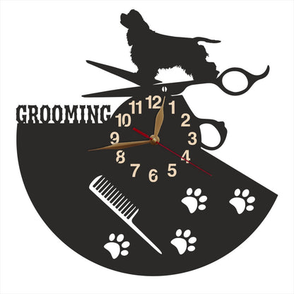 Wall clock with dog grooming design featuring a spaniel, scissors, and comb.