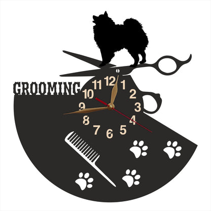 Wall clock with dog grooming design featuring a silhouette of a spitz, scissors, and a comb.