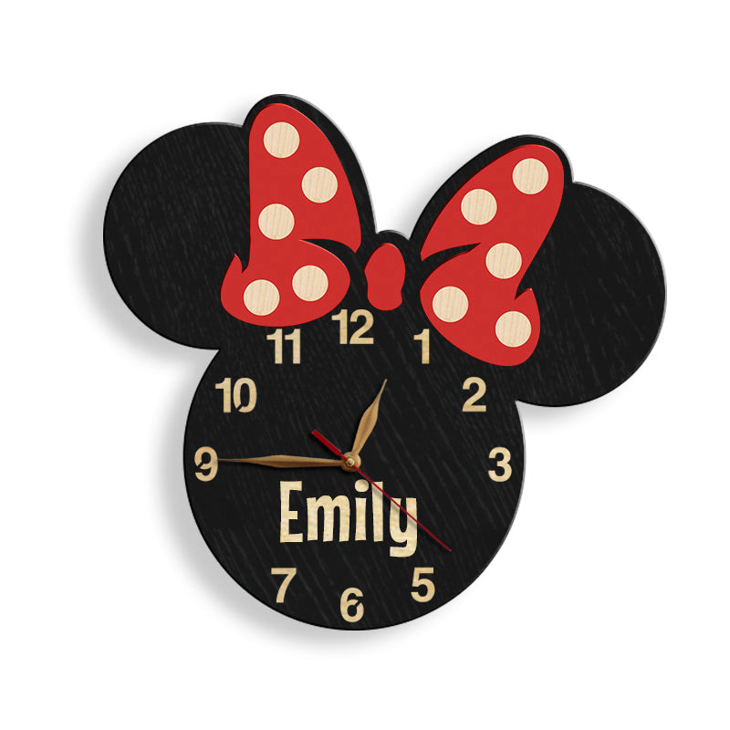 Wall clock designed like a Minnie Mouse with a red bow and black ears, featuring a name