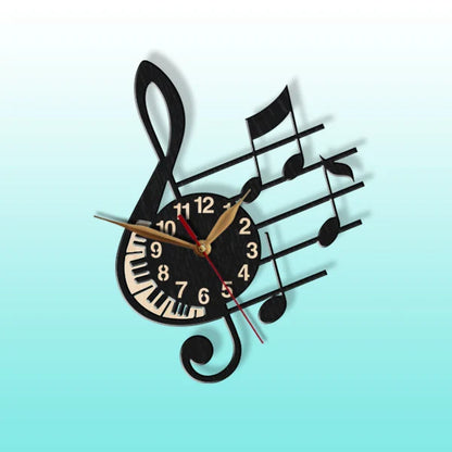 Black musical clock in shape of G-clef and note stave