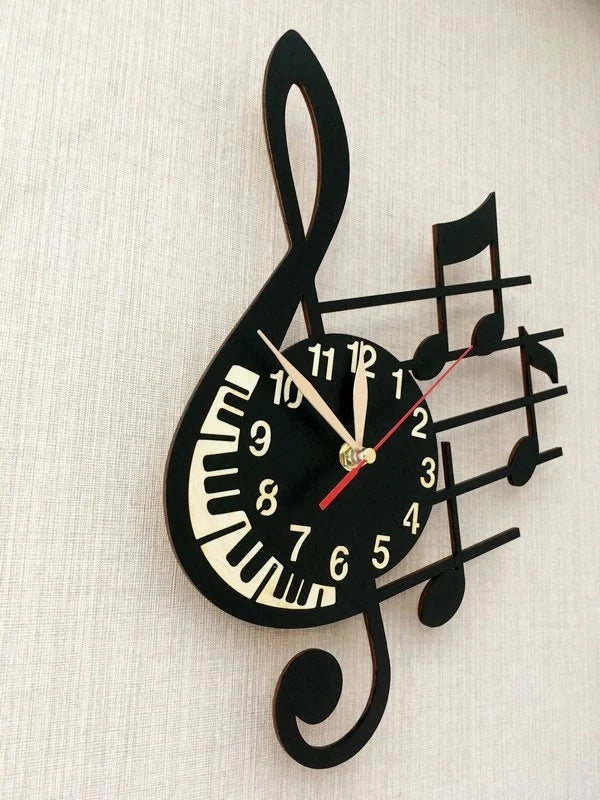 Side view of black and white treble clef clock on beige wall