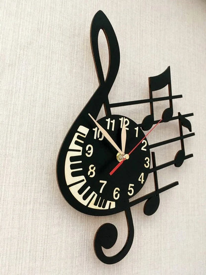 Side view of black and white treble clef clock on beige wall