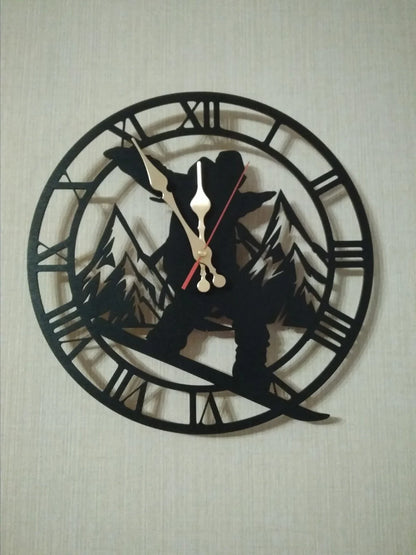 Wall clock featuring snowboarder and alpine trees in classic black cutout style