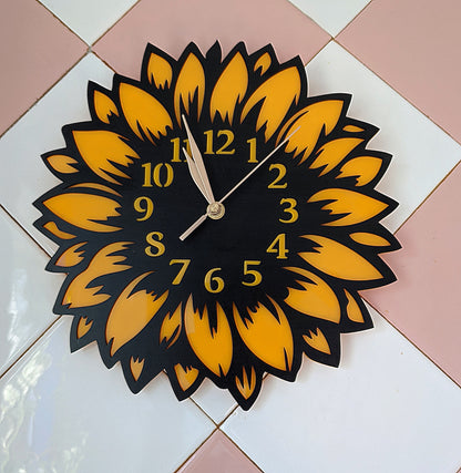 Sunflower wall clock mounted on pink and white tile background