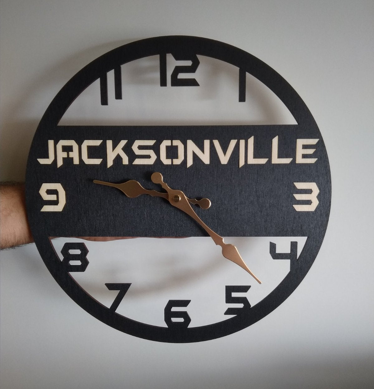 Custom wooden wall clock with the word Jacksonville engraved in the center