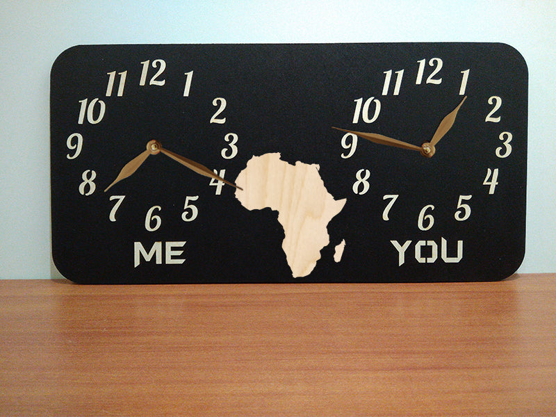 A personalized dual-time wall clock with a black background, featuring Africa map illustration between two sets of hands. The labeles 'ME' and 'YOU' is customized and can be changed to country names