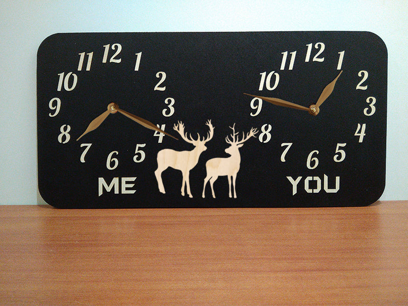 A personalized dual-time wall clock with a black background, featuring deers illustration between two sets of hands. The labeles 'ME' and 'YOU' is customized and can be changed to custom inscriptions