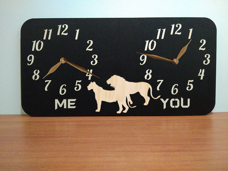 A personalized dual-time wall clock with a black background, featuring lions illustration between two sets of hands. The labeles 'ME' and 'YOU' is customized and can be changed to custom inscriptions