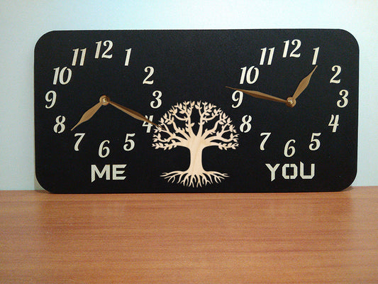 A personalized dual-time wall clock with a black background, featuring a tree illustration between two sets of hands. The labeles 'ME' and 'YOU' is customized and can be changed to custom inscriptions